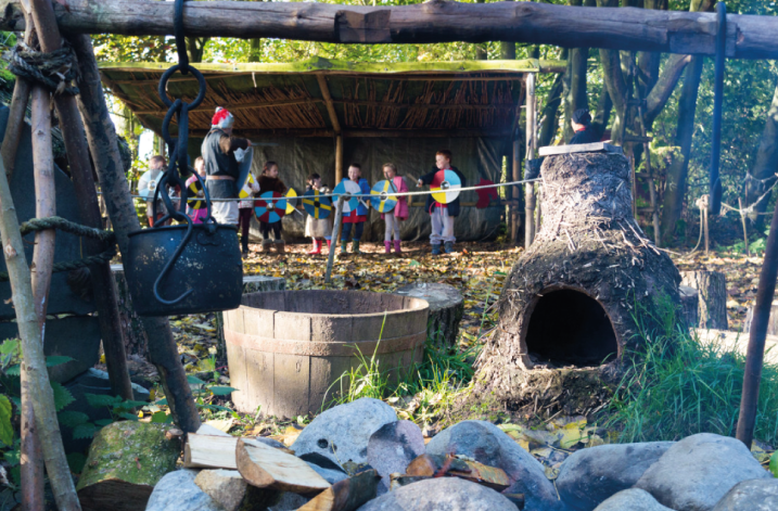 The Mere Tun Village at WWT Martin Mere Wetland Centre, weapons training session in the background.